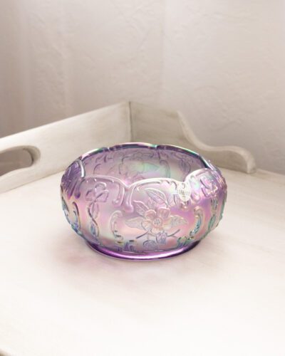 This exquisite Fenton purple floral bowl showcases Fenton's renowned craftsmanship with its mesmerizing iridescent finish and delicate floral patterns, bringing a touch of elegance to any space.